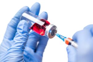 Filling syringe with red liquid medication